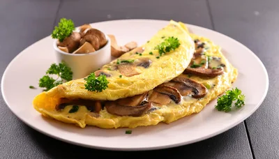 Mushroom Omelet Served On A White Plate