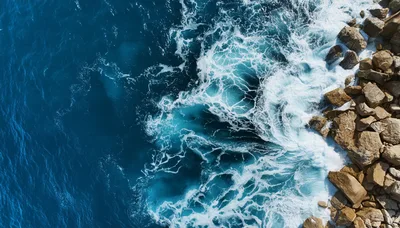 Aerial View Of Ocean Waves Crashing Against Rocky Coastline