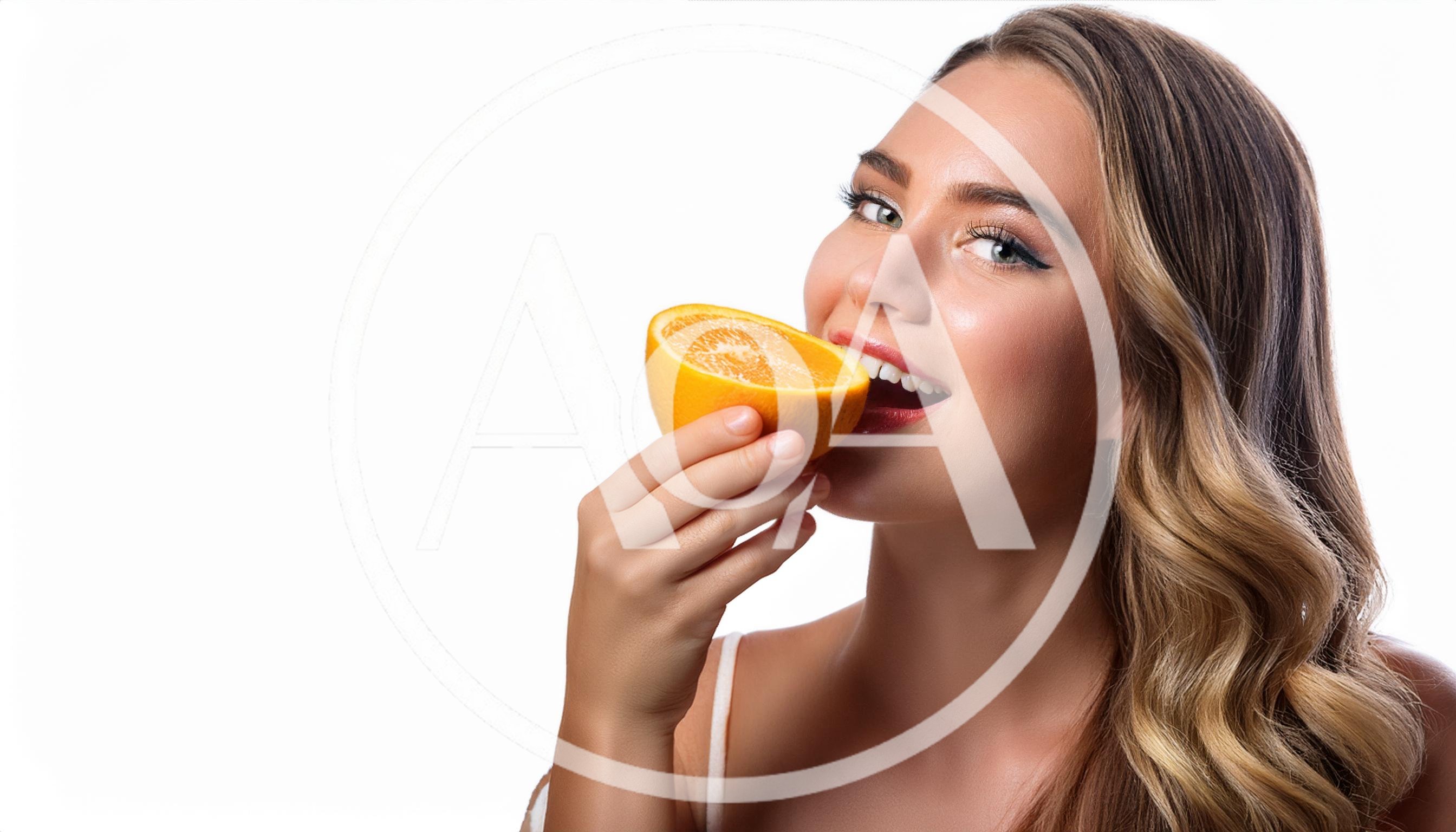 Young Woman Holding A Fresh Orange Slice