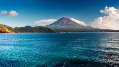 Majestic Volcanic Mountain Rising Above Tropical Ocean Waters