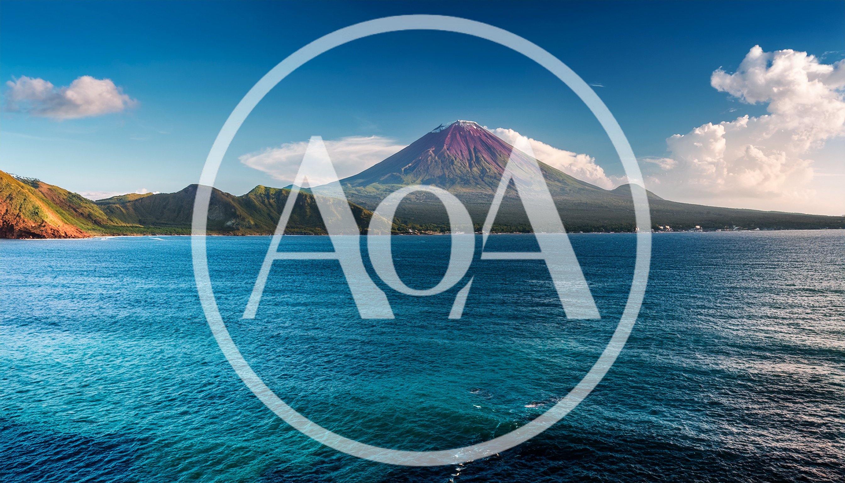 Majestic Volcanic Mountain Rising Above Tropical Ocean Waters