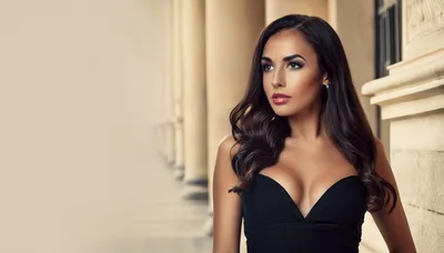 Elegant Woman In Black Dress Posing Near Classical Columns