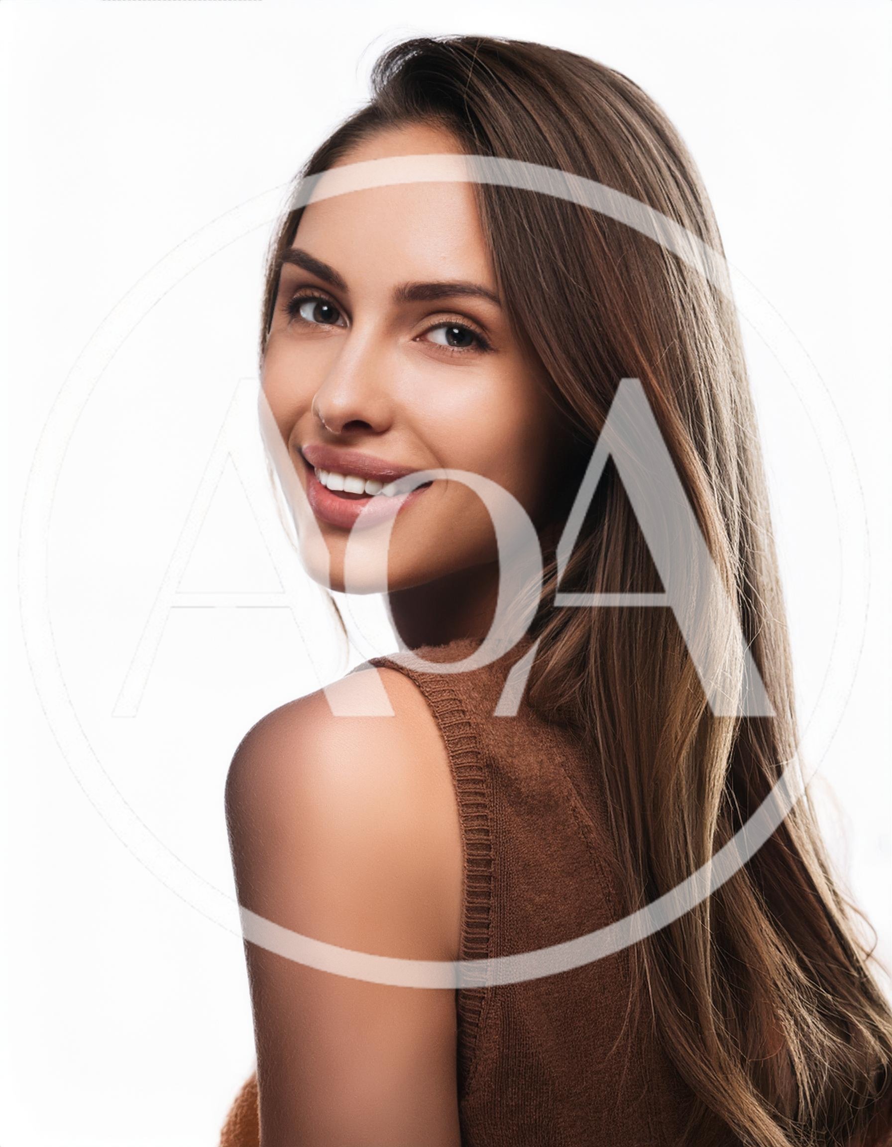 Portrait Of A Smiling Young Woman Looking Back