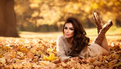 Beautiful Woman Relaxing In Autumn Leaves