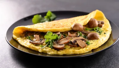 Mushroom Omelet Served On A Black Plate