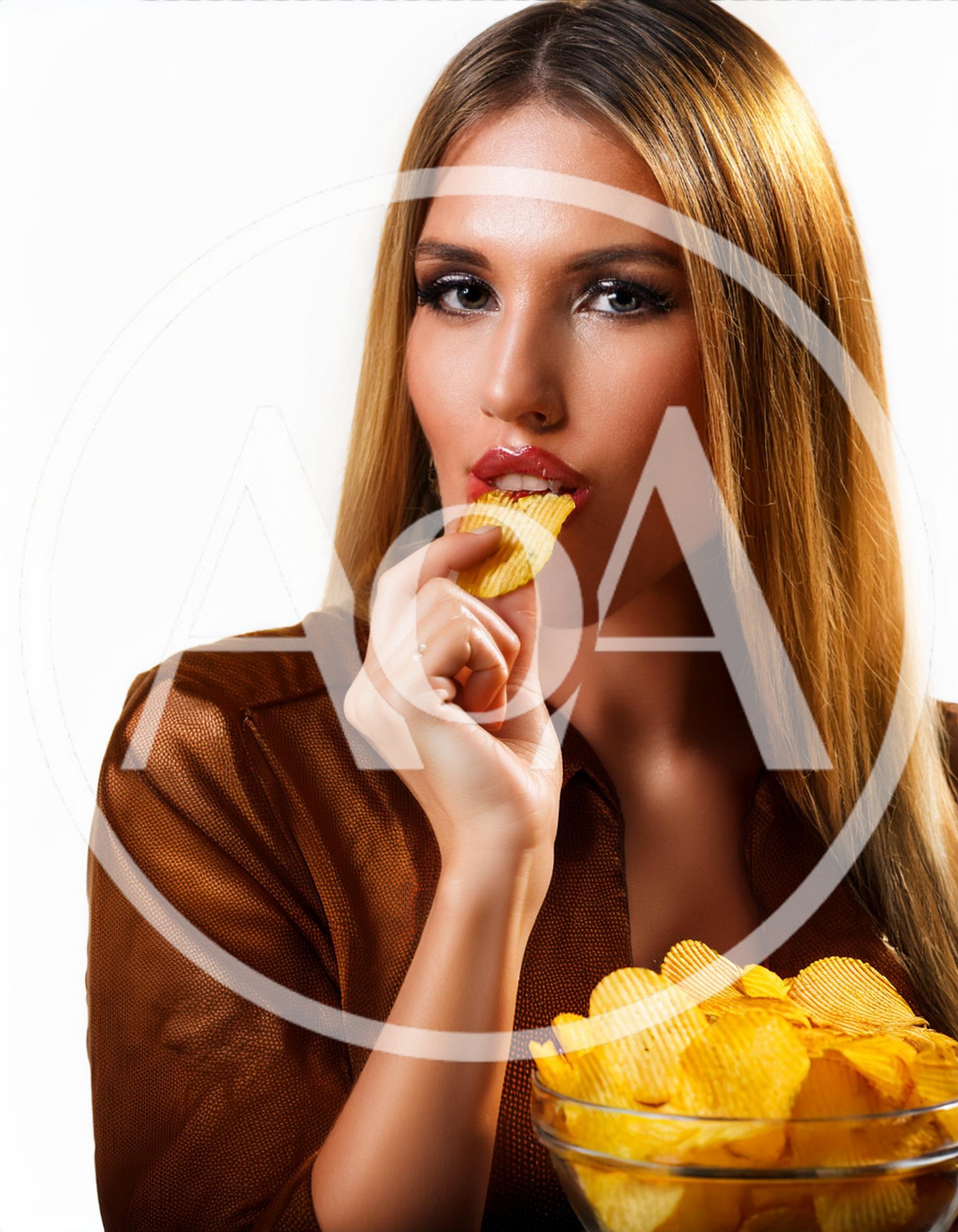 Beautiful Woman Eating Crispy Potato Chips From Glass Bowl