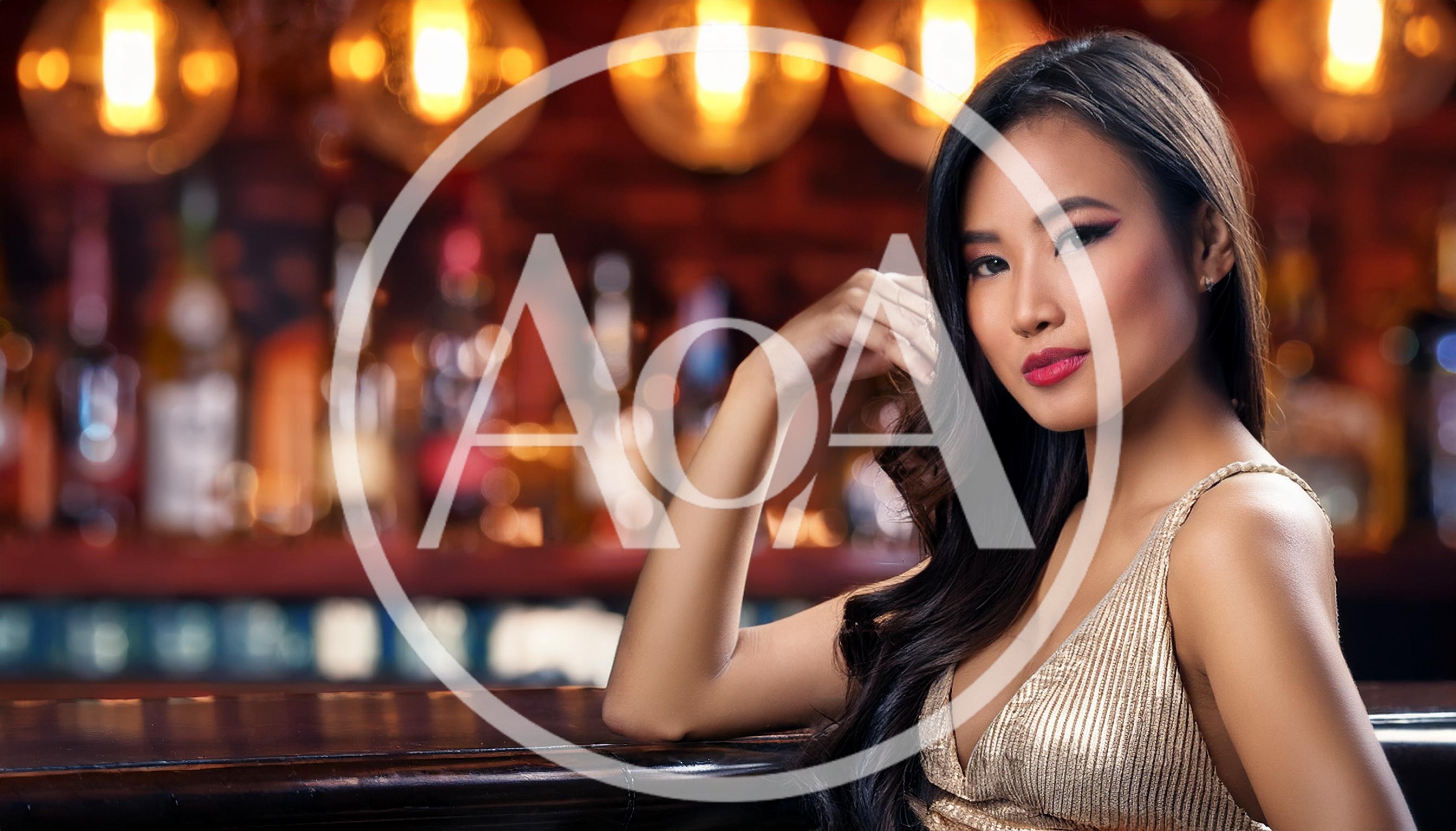 Elegant Asian Woman Posing At A Dimly Lit Bar