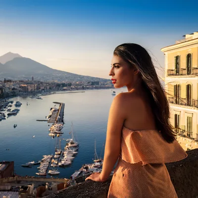 Woman Looking Over The Bay Of Naples At Sunset