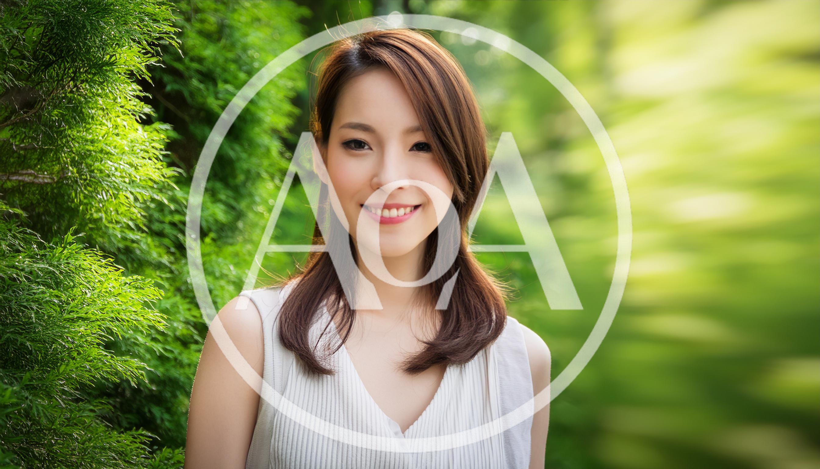Portrait Of A Smiling Young Asian Woman Outdoors