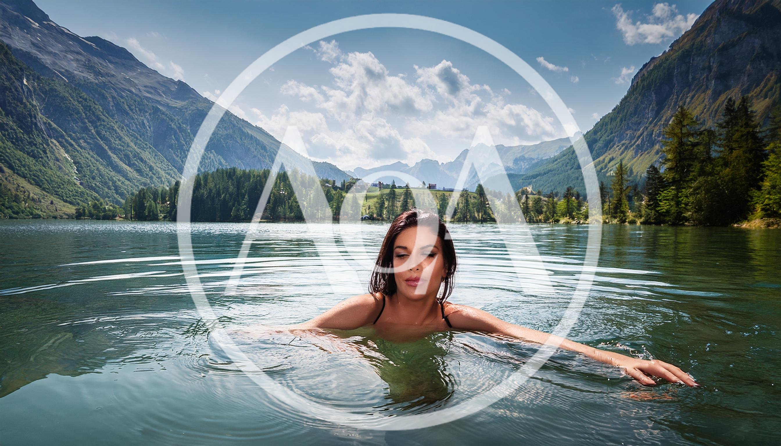 Woman Swimming In A Serene Alpine Lake