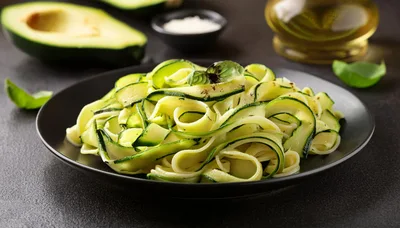 Zucchini Noodles Served on a Black Plate