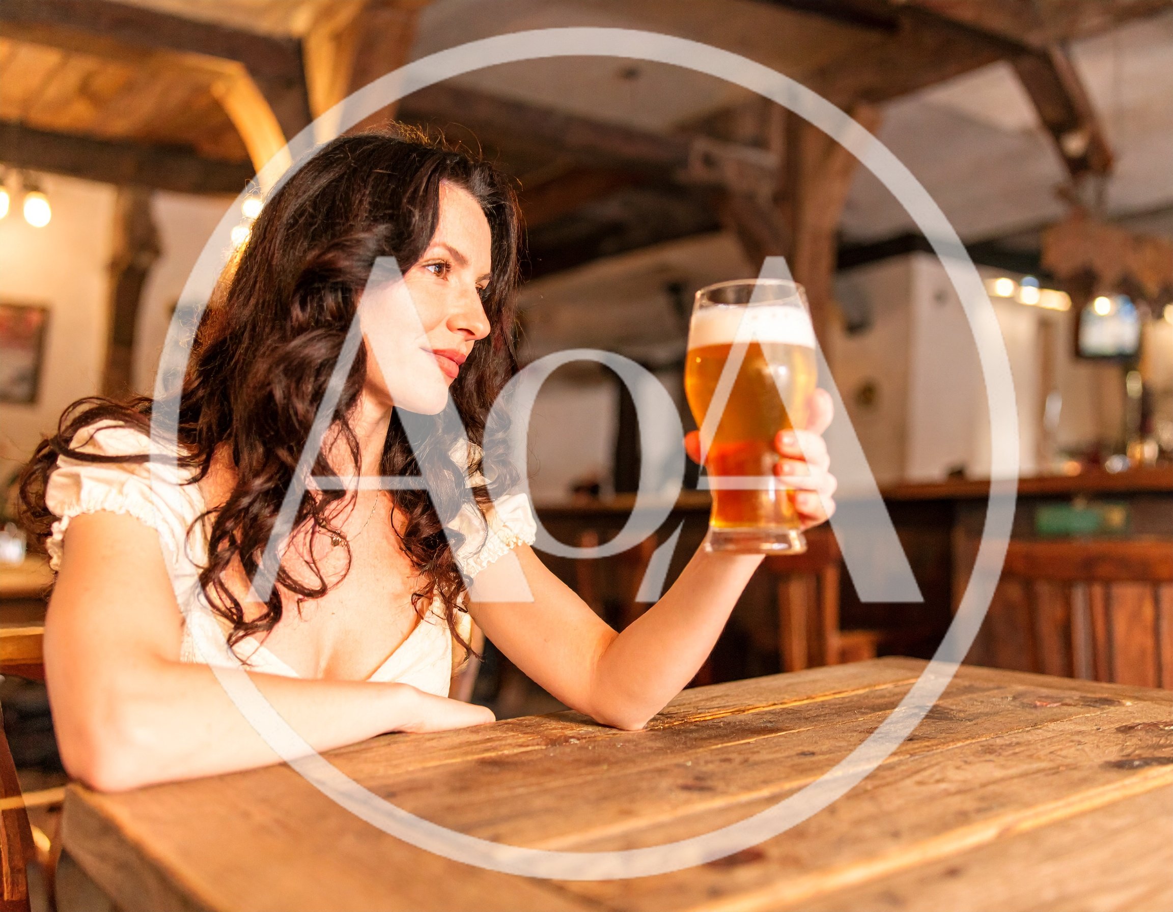Woman Holding A Glass Of Beer In A Tavern