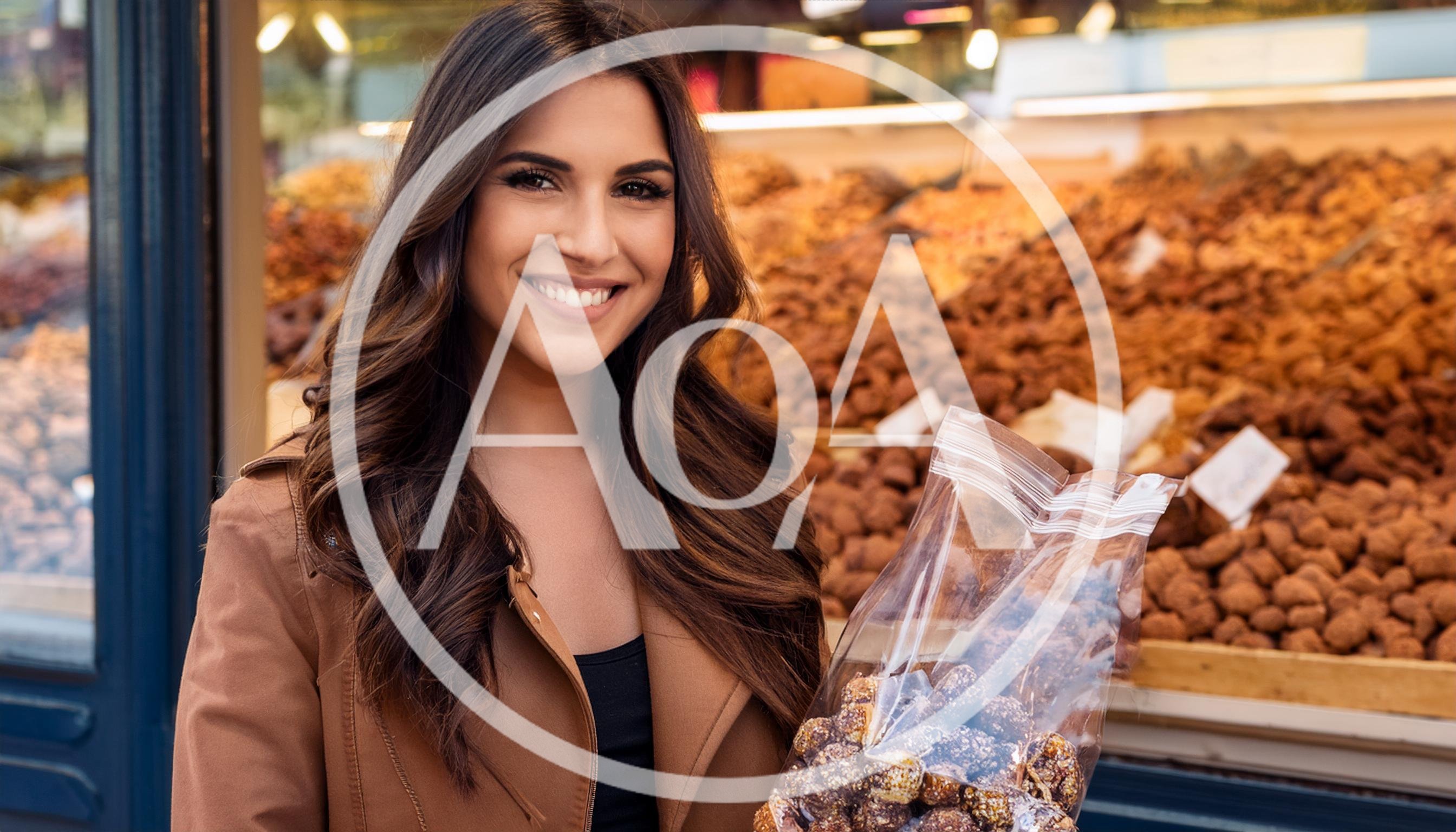 Smiling Woman Holding Bag Of Nuts At Market