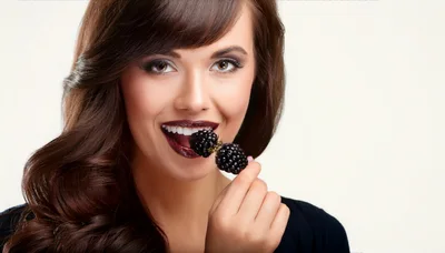 Beautiful Woman Eating Fresh Blackberries