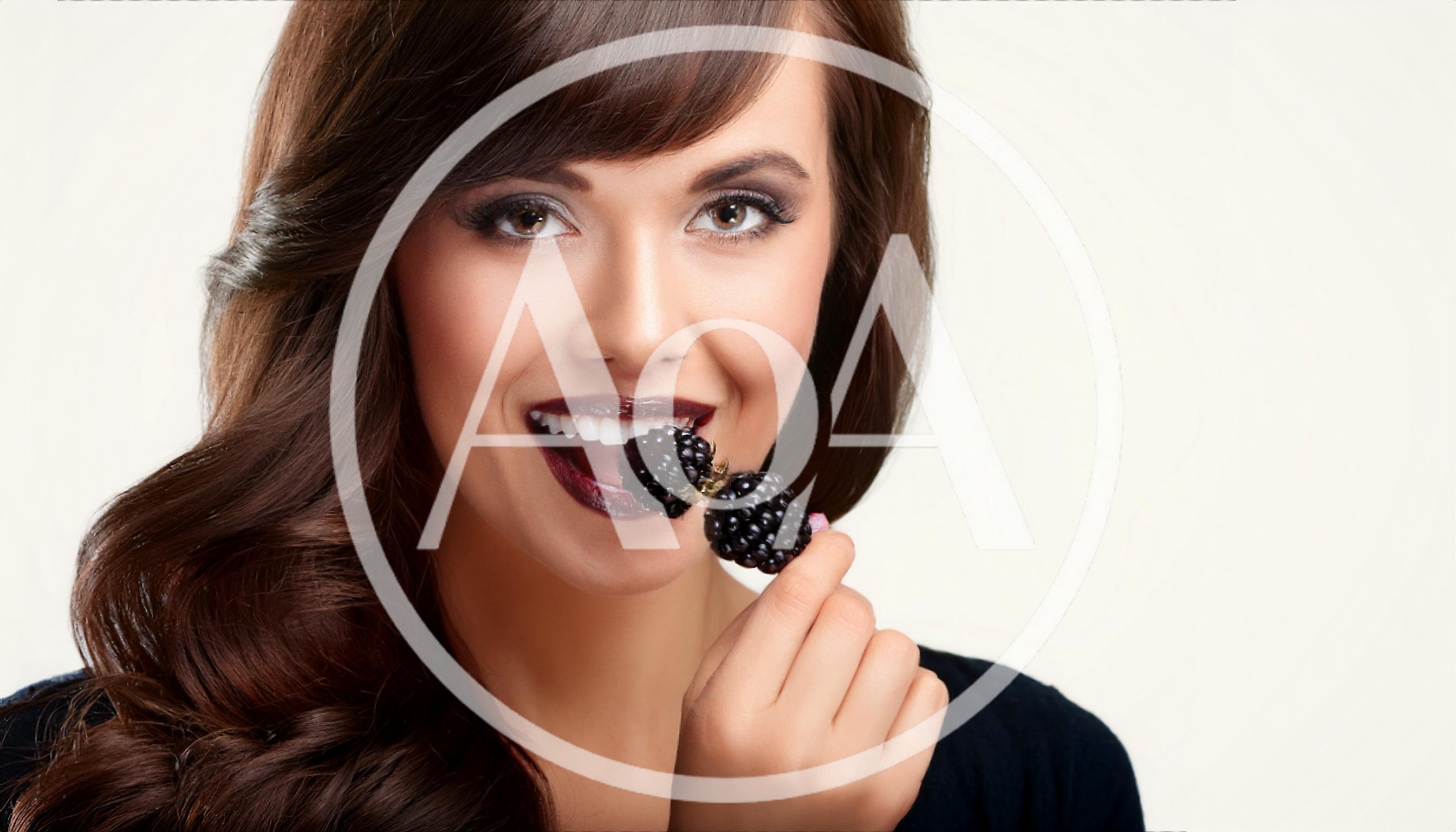 Beautiful Woman Eating Fresh Blackberries