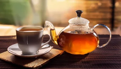 Glass Teapot And White Cup Of Tea
