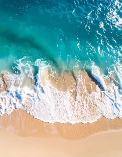 Aerial View Of Turquoise Ocean Waves Crashing On Beach