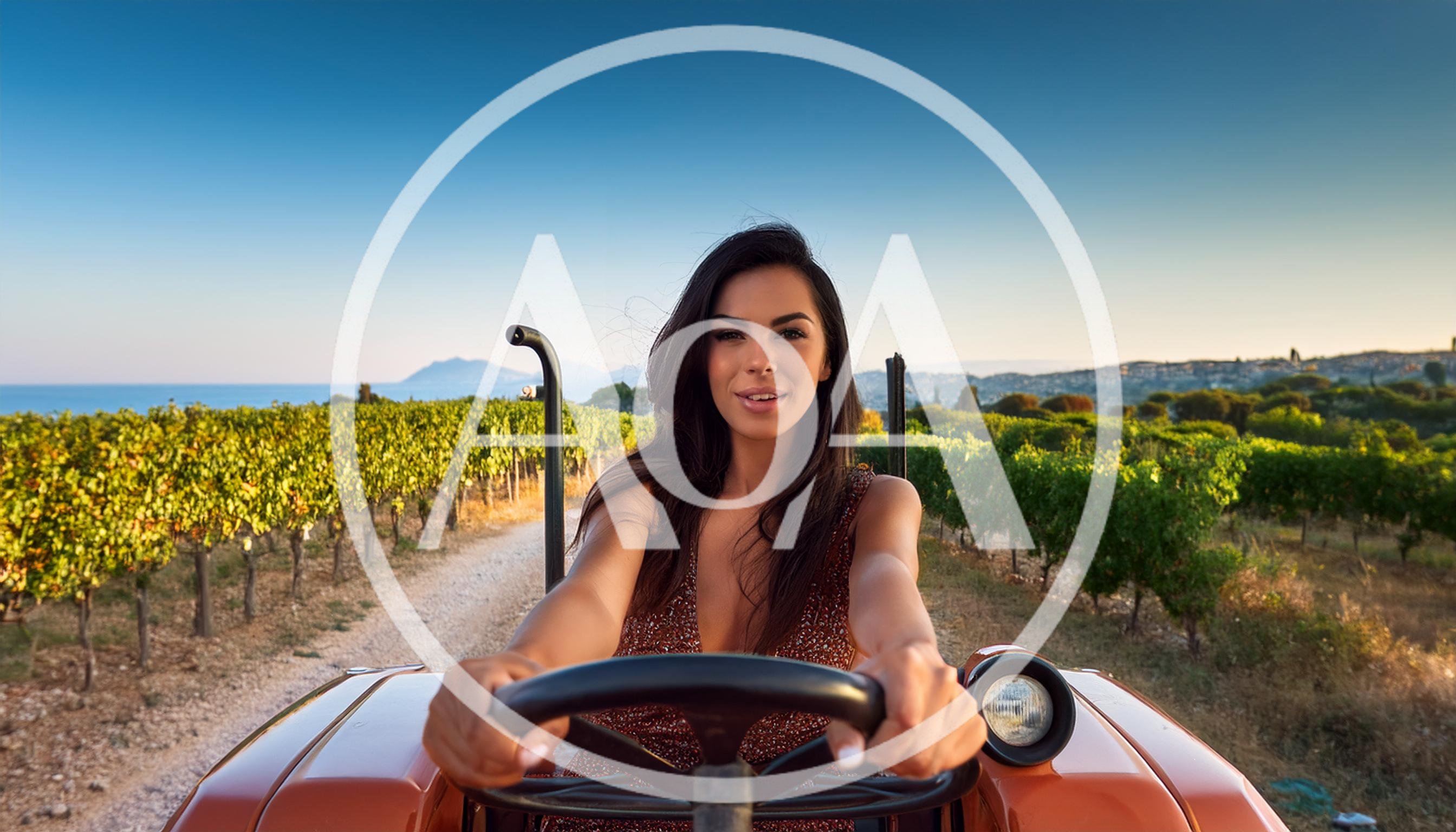 Beautiful Woman Driving A Tractor Through A Vineyard
