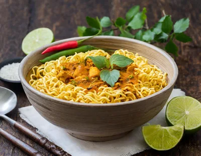 Bowl Of Spicy Thai Curry Noodles With Lime