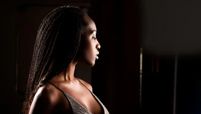 Profile Portrait Of A Young Woman With Braided Hair