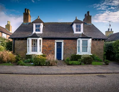 Traditional English Brick Cottage With Blue Front Door