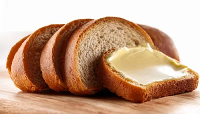 Slices Of Fresh Bread With Butter On Wooden Board