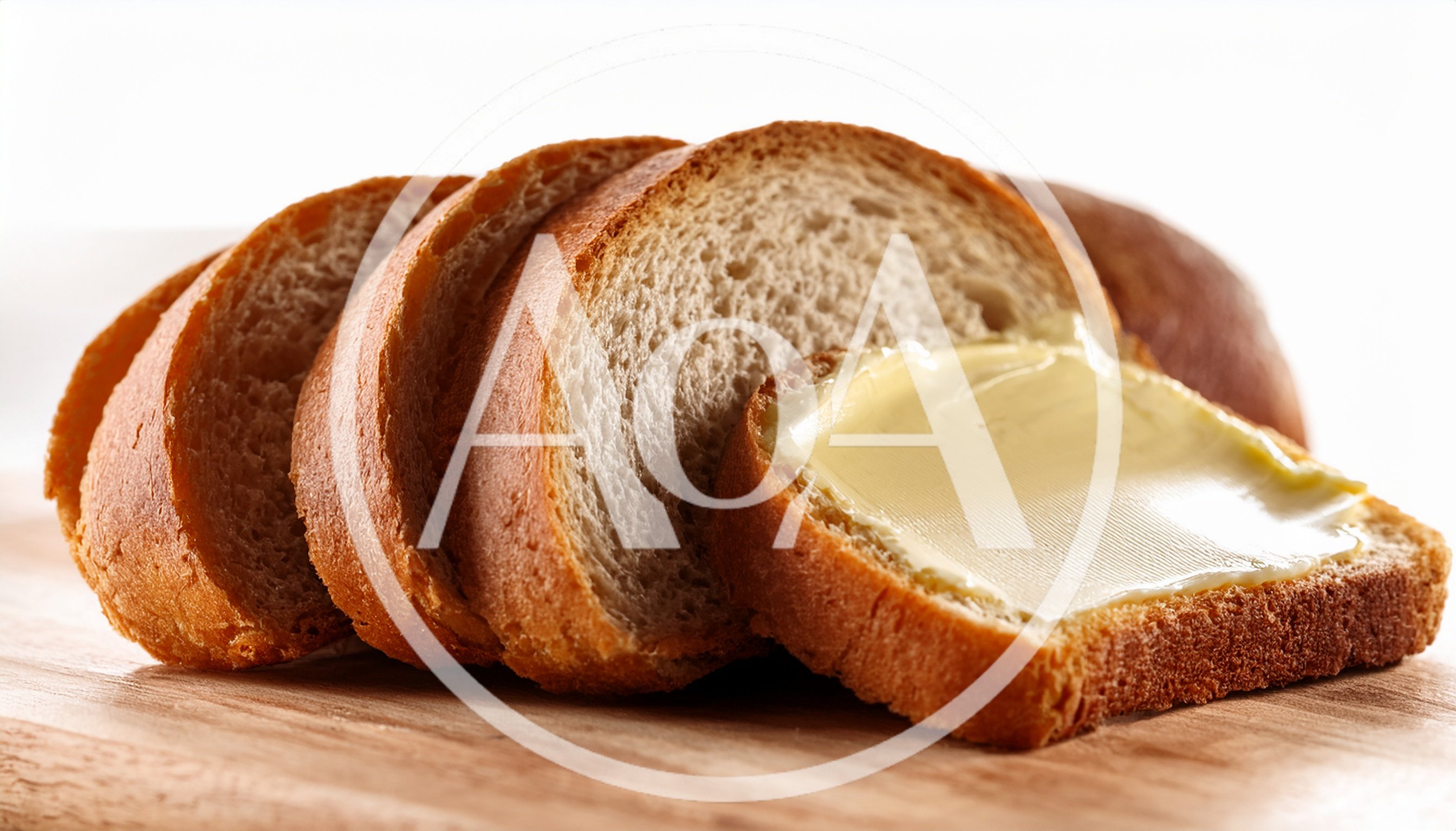 Slices Of Fresh Bread With Butter On Wooden Board