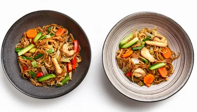 Two Bowls Of Stir Fried Noodles With Vegetables