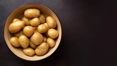 Fresh Raw Potatoes In A Wooden Bowl
