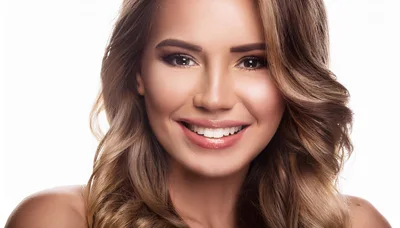 Portrait Of A Smiling Young Woman With Wavy Hair