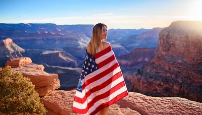 Woman Wrapped In American Flag At Grand Canyon