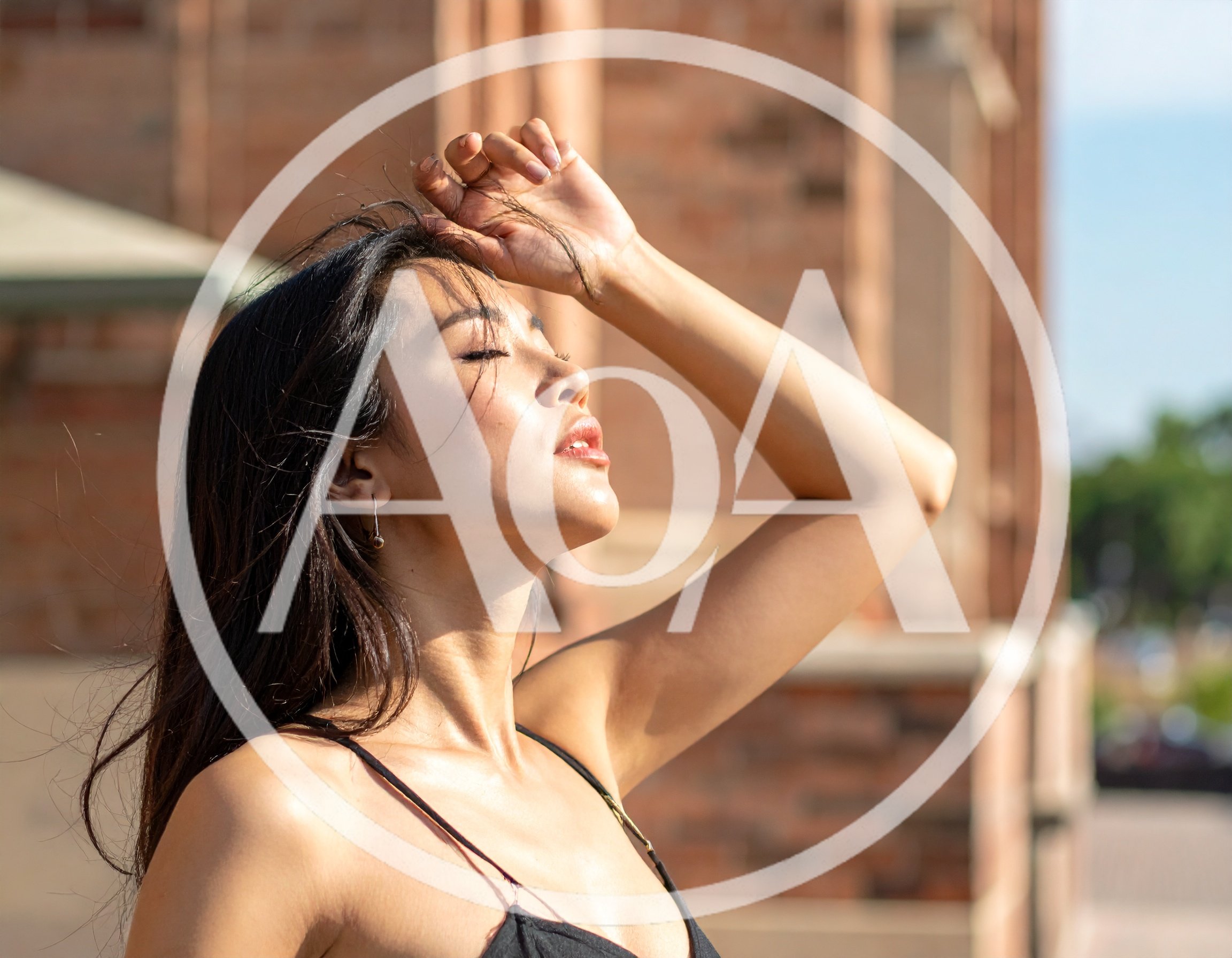 Young Woman Posing Outdoors With Hand On Forehead