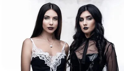 Two Beautiful Women With Dark Makeup Posing Together