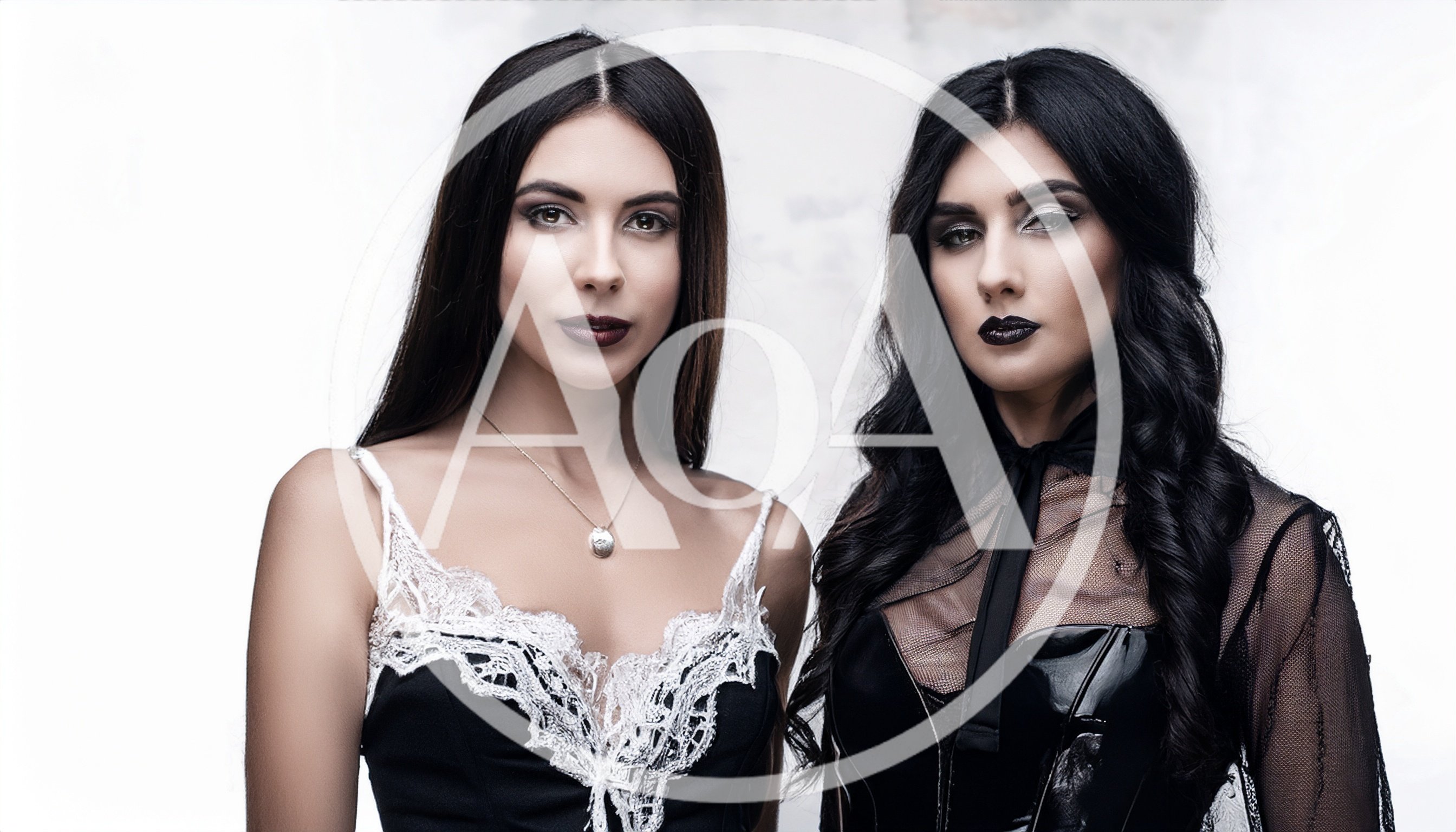 Two Beautiful Women With Dark Makeup Posing Together