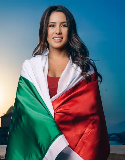 Young Woman Wrapped In Italian Flag At Sunset
