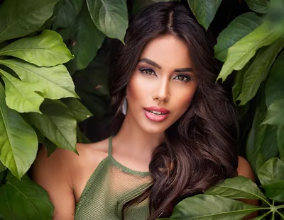 Portrait Of A Beautiful Woman Surrounded By Lush Foliage