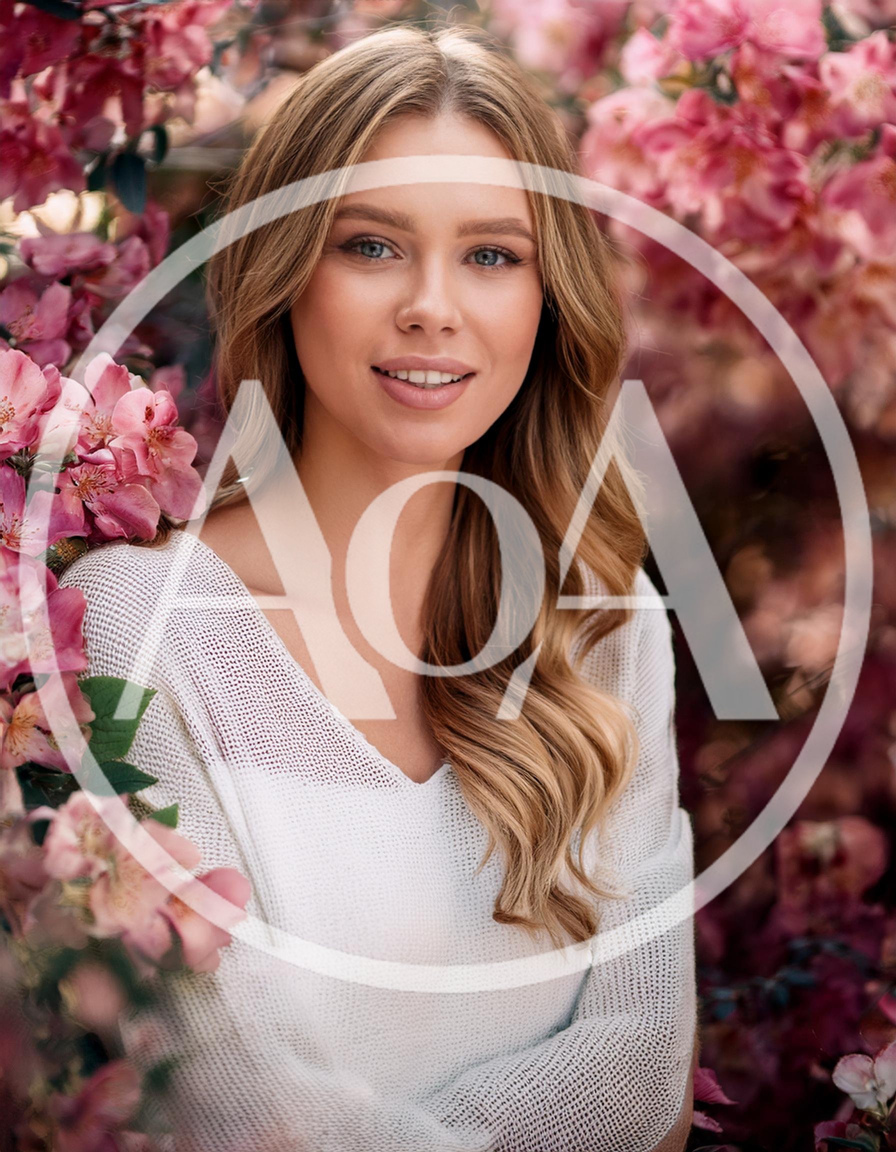 Portrait Of A Beautiful Woman Among Blooming Flowers