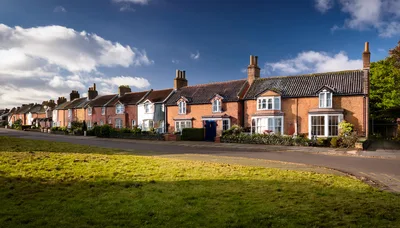 Row Of Traditional English Brick Cottages In Village
