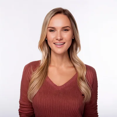 Portrait Of A Smiling Blonde Woman In A Sweater