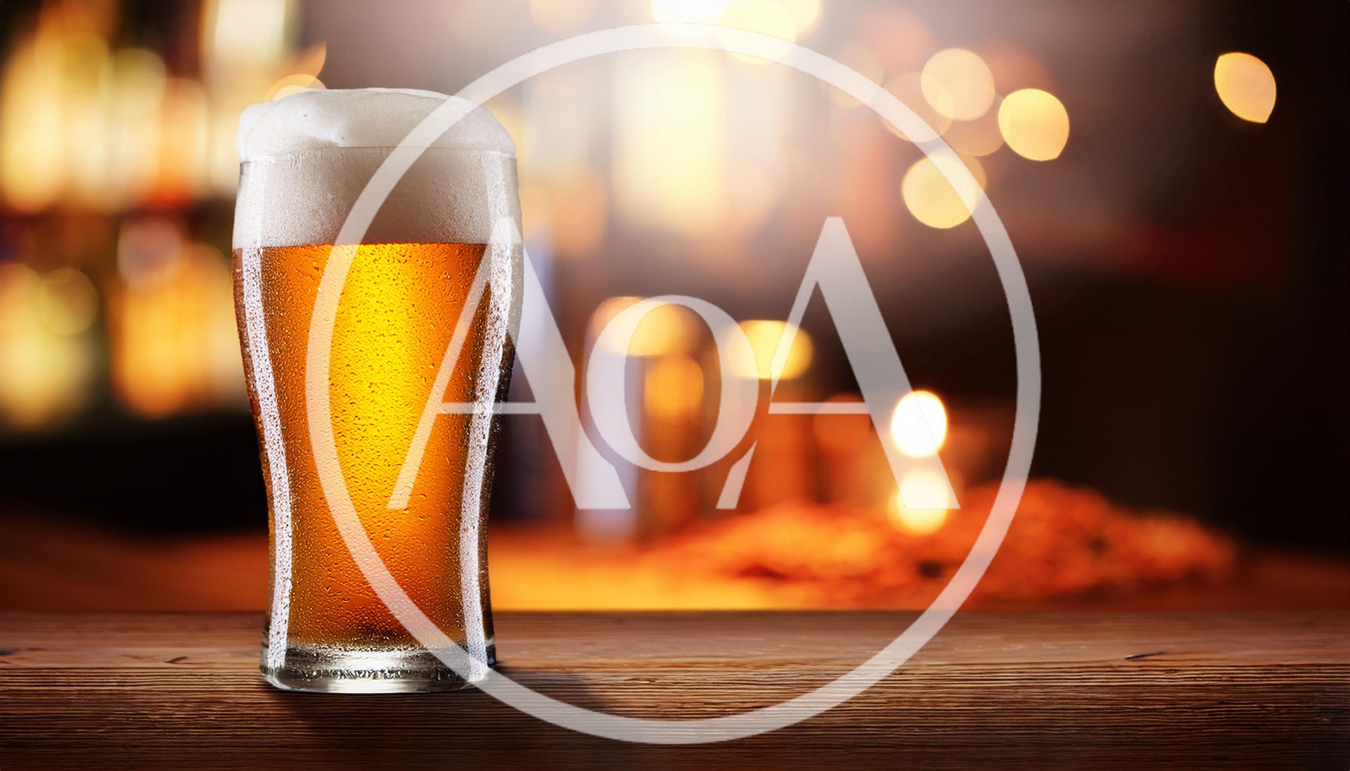 Cold Glass Of Beer On A Wooden Bar Counter