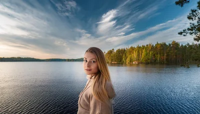 Young Woman Standing By A Serene Forest Lake