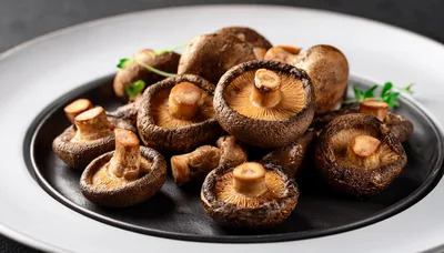 Fresh Shiitake Mushrooms Arranged On A Black Plate