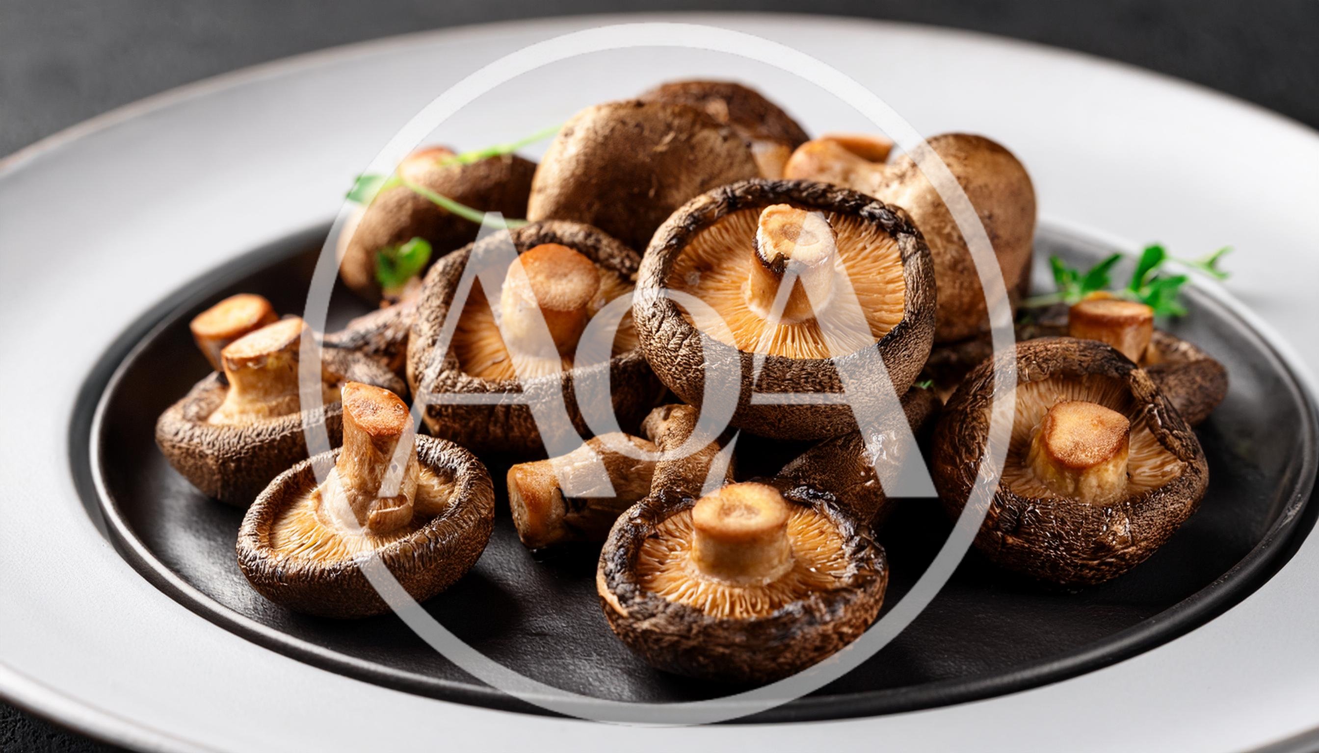 Fresh Shiitake Mushrooms Arranged On A Black Plate