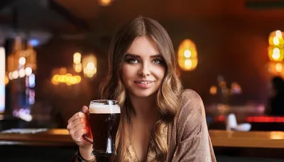 Young Woman Holding A Glass Of Dark Beer