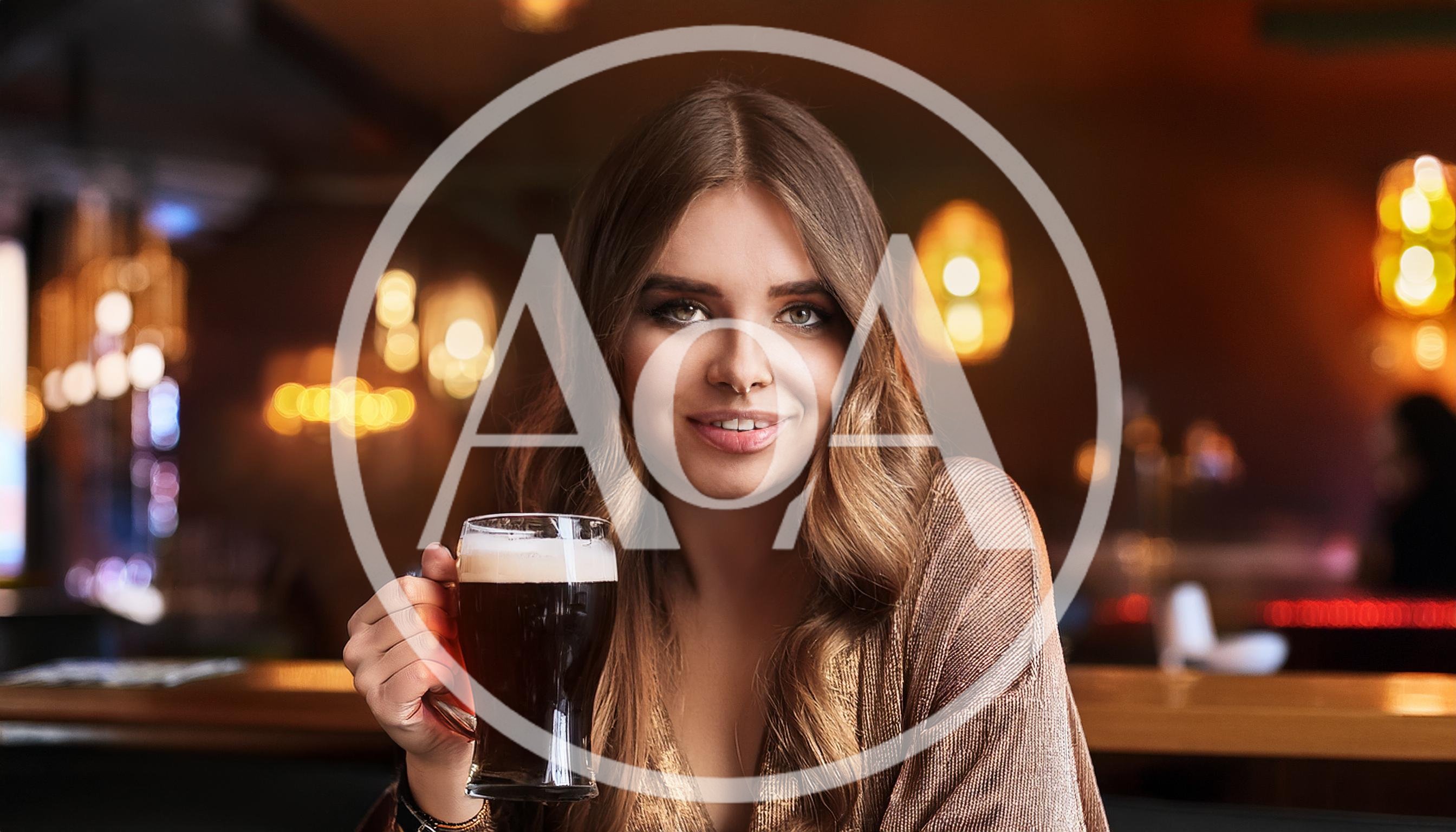 Young Woman Holding A Glass Of Dark Beer