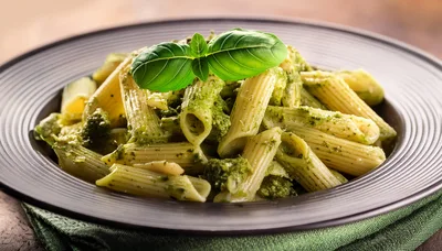 Penne Pasta With Pesto Sauce In A Bowl