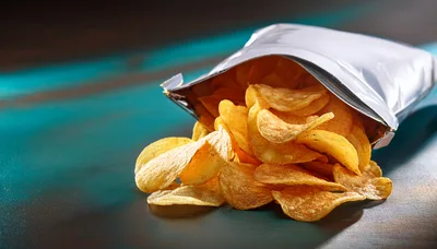 Potato Chips Spilled From A Silver Bag