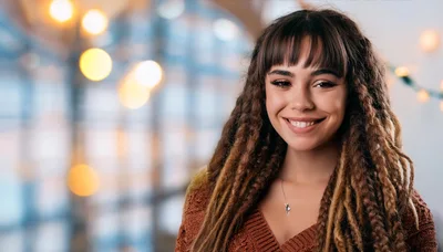 Portrait Of A Smiling Young Woman With Dreadlocks