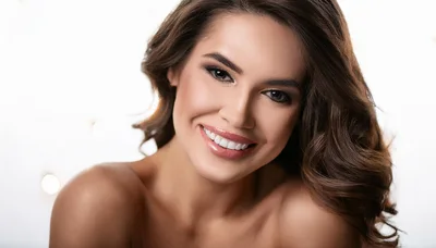 Portrait Of A Smiling Woman With Wavy Brown Hair
