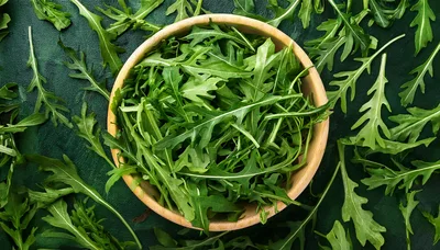 Fresh Arugula Leaves In A Wooden Bowl
